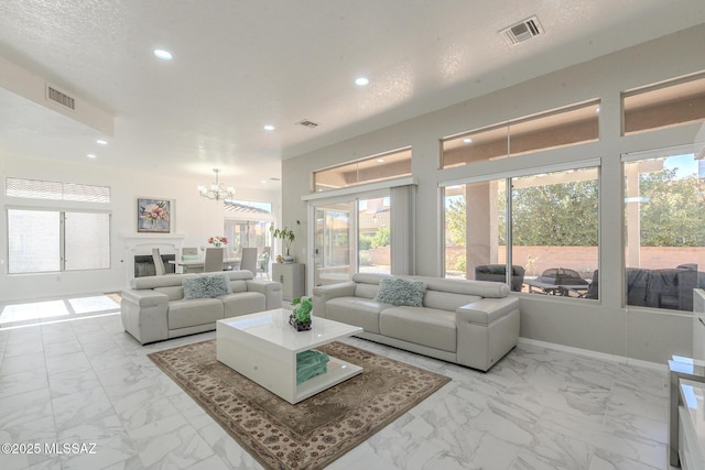 living room featuring marble finish floor, visible vents, a notable chandelier, and recessed lighting