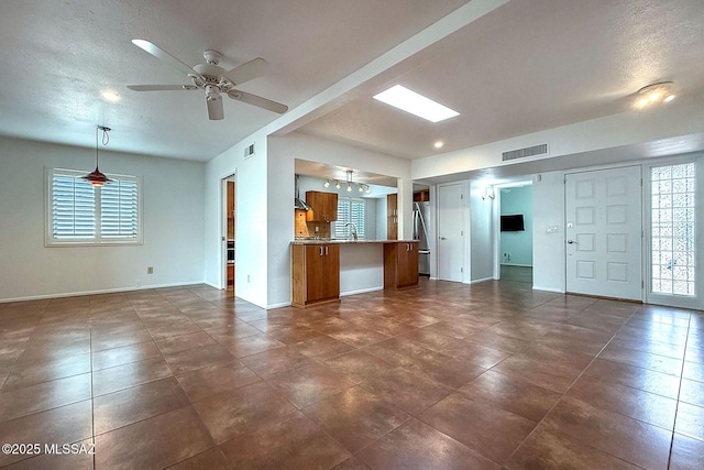 7471 E Serenity Ln, Tucson, AZ 85750 - unfurnished living room with baseboards, a ceiling fan, and dark tile patterned floors