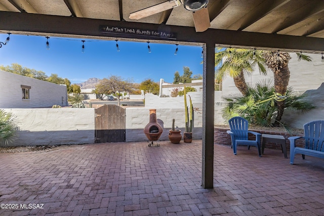 7471 E Serenity Ln, Tucson, AZ 85750 - view of patio / terrace featuring ceiling fan, a gate, and a mountain view