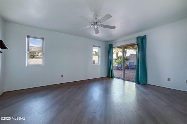 7471 E Serenity Ln, Tucson, AZ 85750 - unfurnished room with plenty of natural light, dark wood-style flooring, a ceiling fan, and baseboards