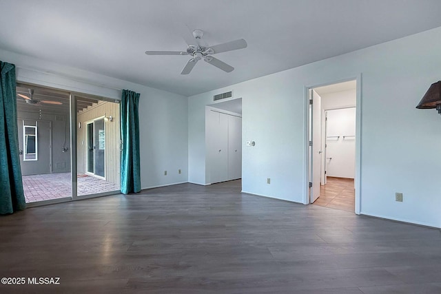 7471 E Serenity Ln, Tucson, AZ 85750 - unfurnished bedroom featuring dark wood-style floors, access to outside, and baseboards
