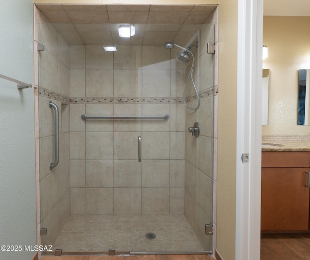 bathroom featuring a stall shower and vanity