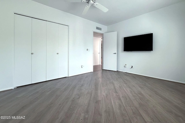 7471 E Serenity Ln, Tucson, AZ 85750 - unfurnished bedroom featuring wood finished floors, a closet, ceiling fan, and baseboards