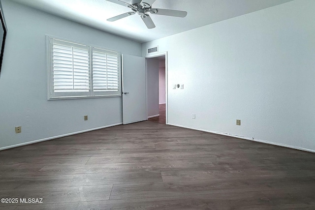 7471 E Serenity Ln, Tucson, AZ 85750 - spare room featuring dark wood-style flooring, a ceiling fan, and baseboards