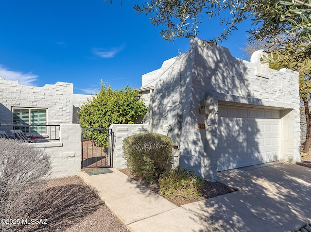 view of property exterior with a garage, a gate, and fence