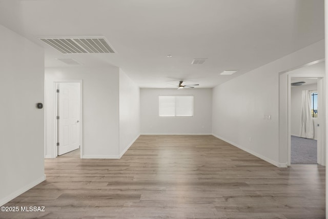 11012 E Ava Marie Pl, Tucson, AZ 85747 - spare room featuring a ceiling fan, light wood-style flooring, and baseboards