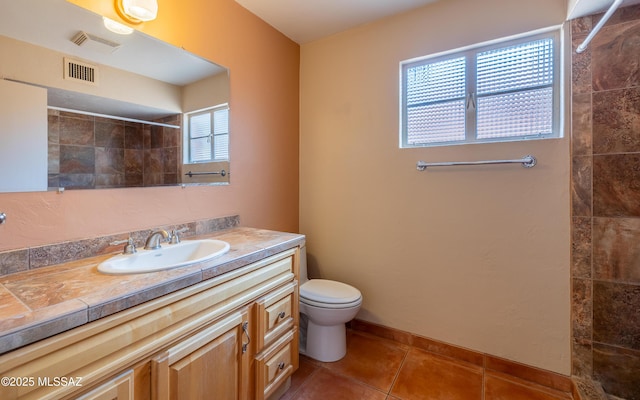 full bath with tile patterned flooring, toilet, vanity, visible vents, and a tile shower