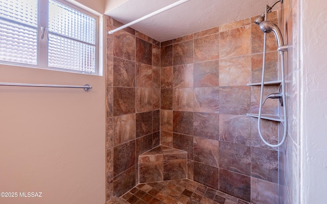 bathroom with tiled shower