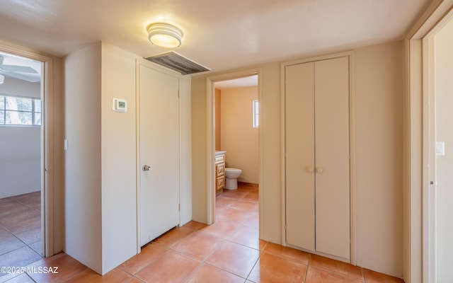 corridor with light tile patterned floors and visible vents