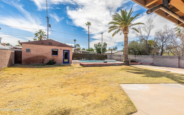 view of yard with a fenced backyard and an outbuilding