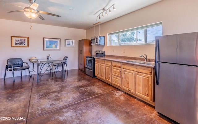 kitchen with dark countertops, ceiling fan, appliances with stainless steel finishes, concrete floors, and a sink