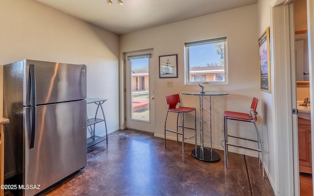 interior space with finished concrete flooring and baseboards