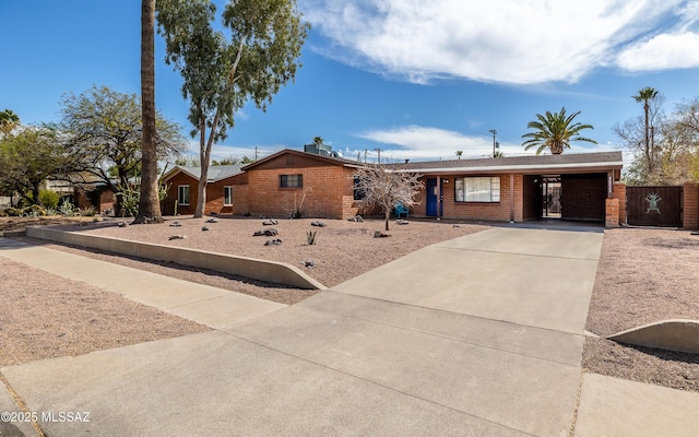 single story home with concrete driveway and brick siding