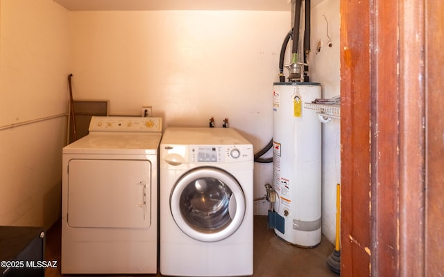 laundry room featuring laundry area, water heater, and separate washer and dryer