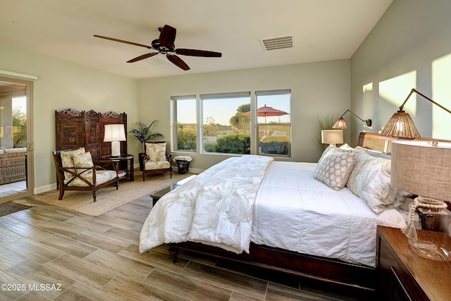 bedroom featuring ceiling fan, wood finish floors, visible vents, and baseboards