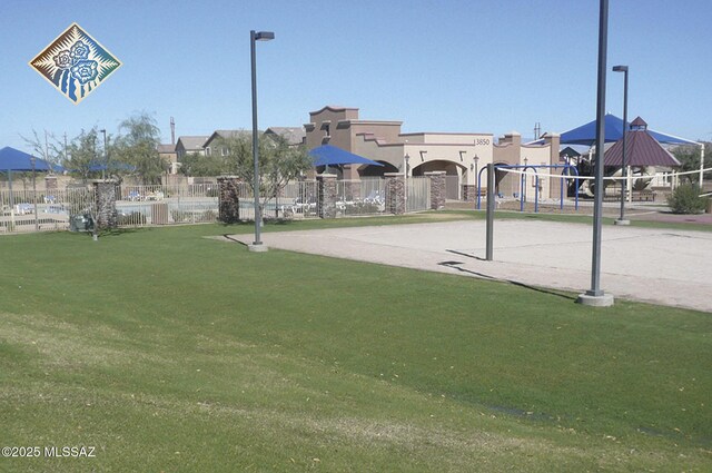 surrounding community with a yard and fence