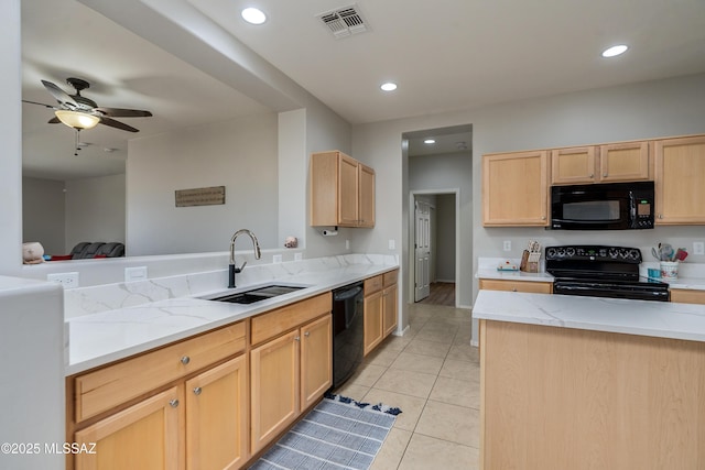 kitchen featuring light tile patterned floors, visible vents, black appliances, light brown cabinets, and a sink