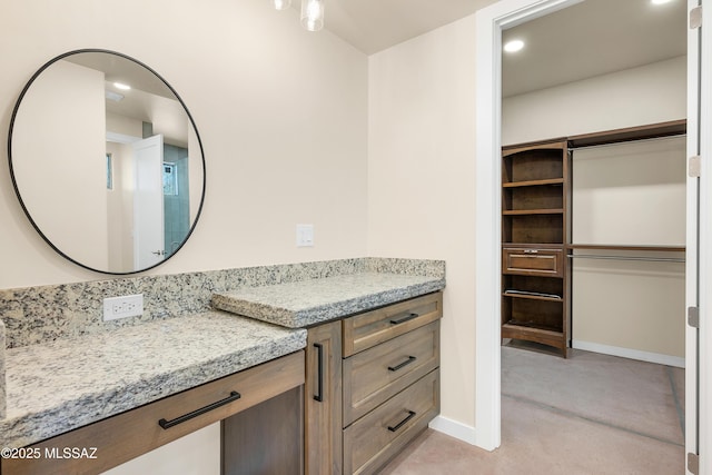 bathroom featuring recessed lighting, vanity, and baseboards