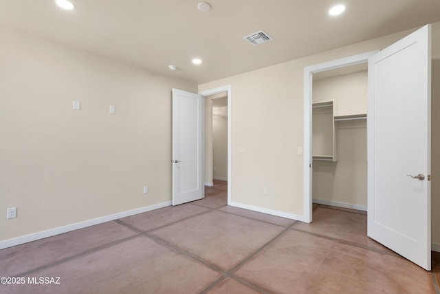 unfurnished bedroom with baseboards, concrete floors, visible vents, and recessed lighting