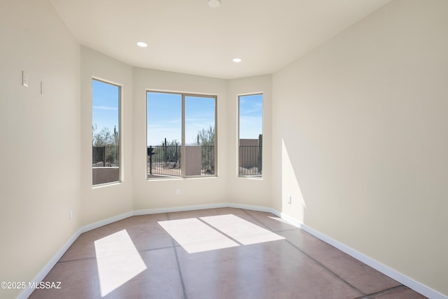 spare room featuring baseboards and recessed lighting