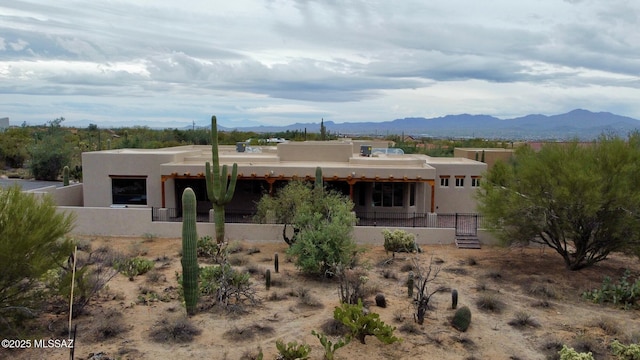 view of front of house with a mountain view and stucco siding