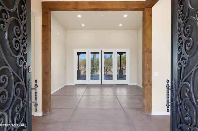 foyer featuring baseboards and recessed lighting