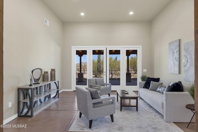entrance foyer with recessed lighting, baseboards, concrete floors, and french doors