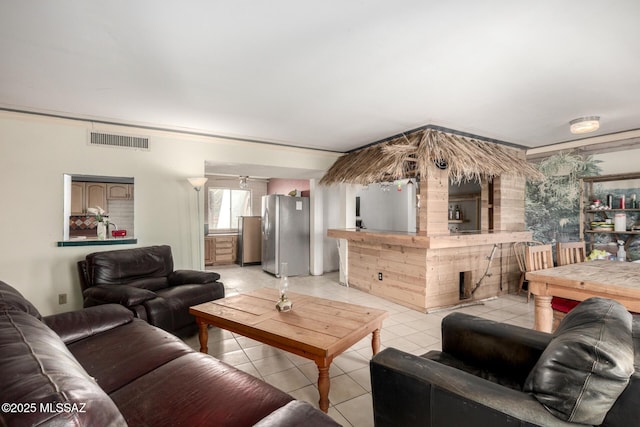 living room featuring light tile patterned flooring and visible vents