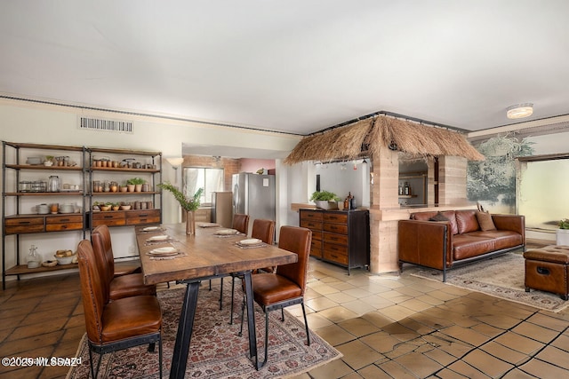 dining space with visible vents and a baseboard radiator