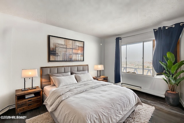 bedroom with a textured ceiling and wood finished floors