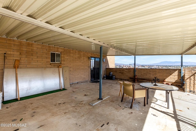 view of patio / terrace featuring fence and a mountain view