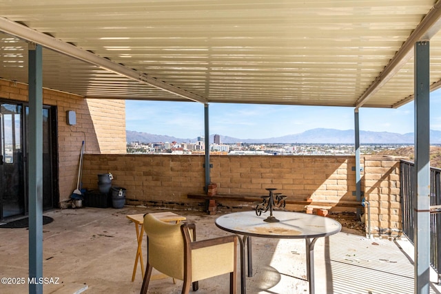 view of patio / terrace with a mountain view and fence