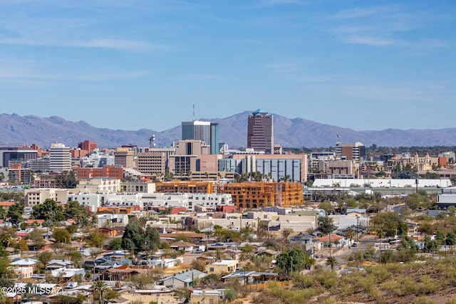 property's view of city with a mountain view
