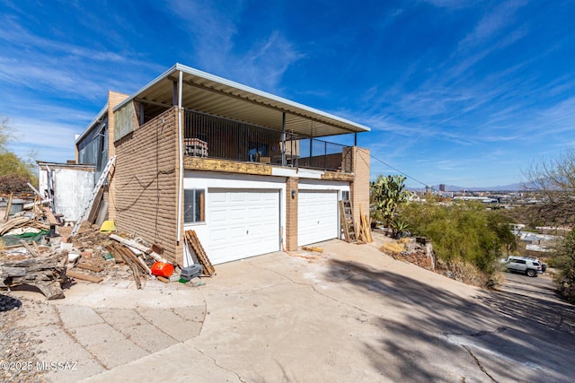 view of home's exterior with an attached garage and driveway
