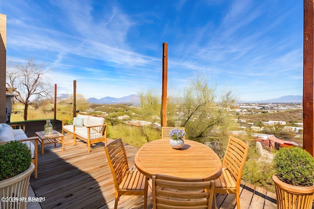 deck with a mountain view and an outdoor hangout area