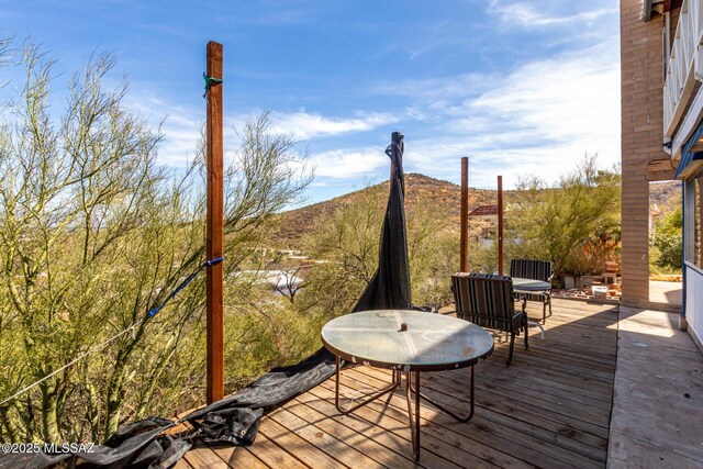 wooden terrace with outdoor dining space