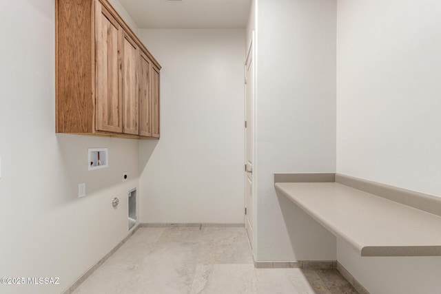 washroom with hookup for a washing machine, cabinet space, baseboards, and hookup for an electric dryer