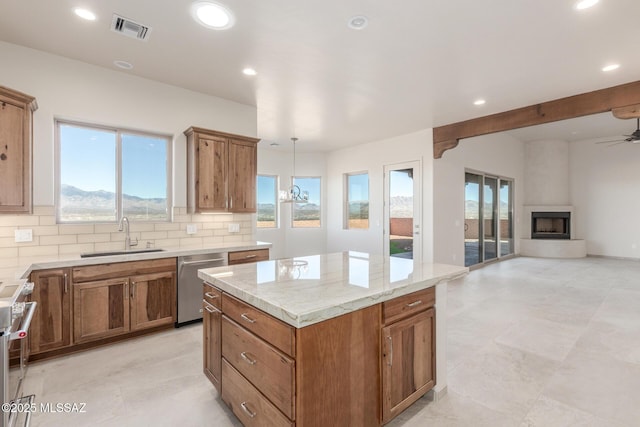 kitchen with a fireplace, visible vents, backsplash, a sink, and dishwasher