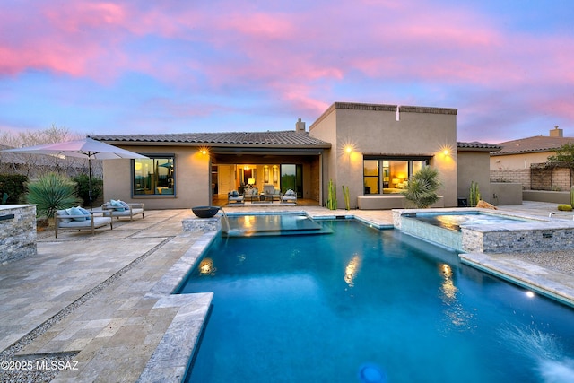 view of swimming pool with a pool with connected hot tub and a patio