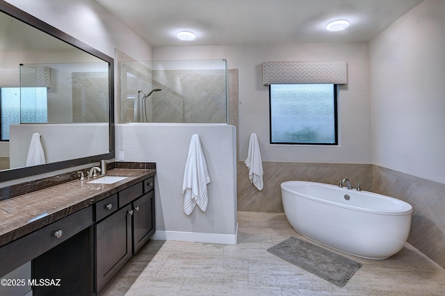 full bath featuring a soaking tub, a walk in shower, tile walls, and vanity