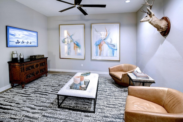 living area featuring ceiling fan, baseboards, and recessed lighting