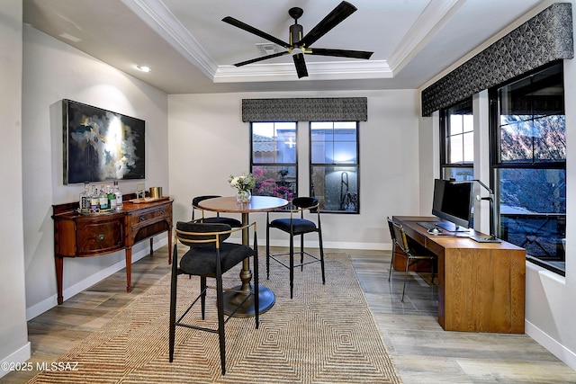 interior space featuring crown molding, a raised ceiling, visible vents, wood finished floors, and baseboards