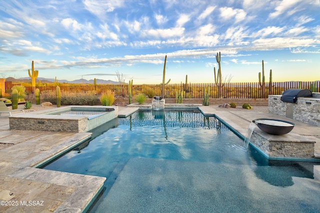 view of pool featuring a patio, grilling area, a fenced backyard, and a pool with connected hot tub