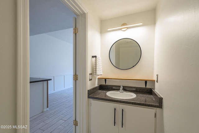 bathroom with vanity and wood finished floors