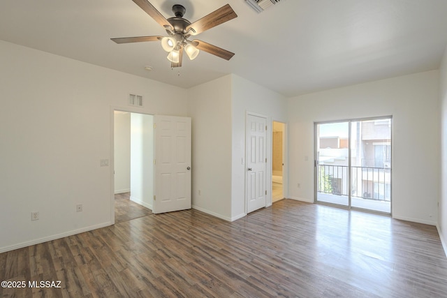 unfurnished bedroom featuring baseboards, visible vents, access to outside, and wood finished floors