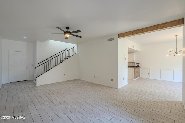 unfurnished living room with light wood finished floors, visible vents, beamed ceiling, stairs, and ceiling fan with notable chandelier