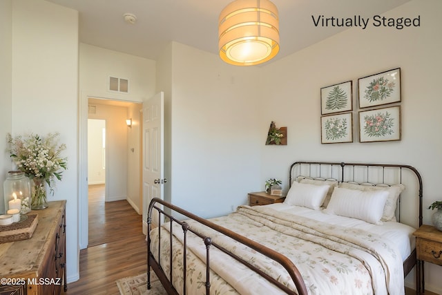 bedroom with wood finished floors and visible vents