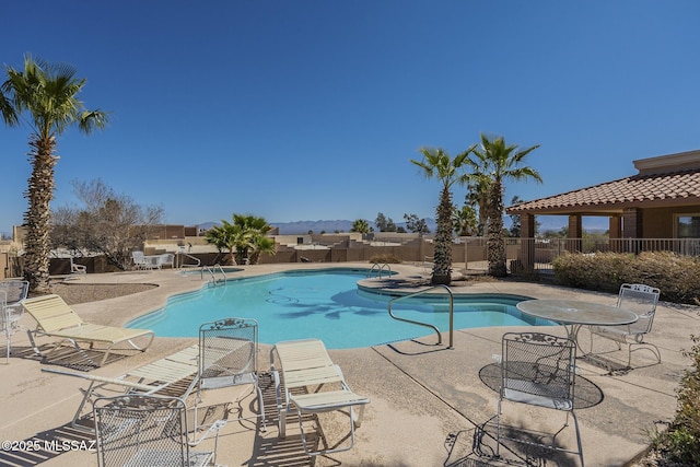 pool with fence and a patio