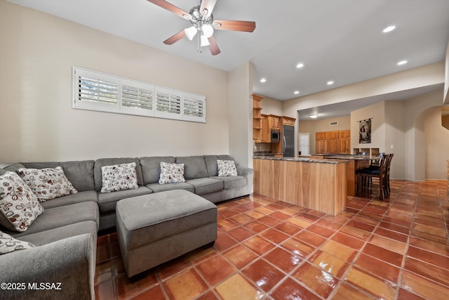 living room with tile patterned floors and ceiling fan