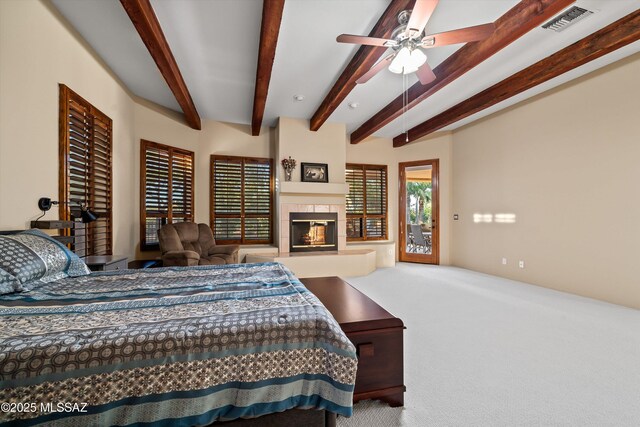 bedroom featuring ceiling fan, beamed ceiling, and light carpet